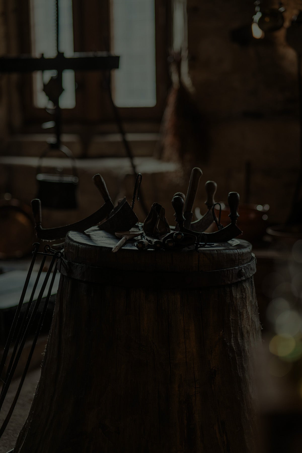A wooden barrel covered with blacksmithing tools, representing the craftsmanship and practicality of the Artisan collection by Fabled Fox Clothiers.