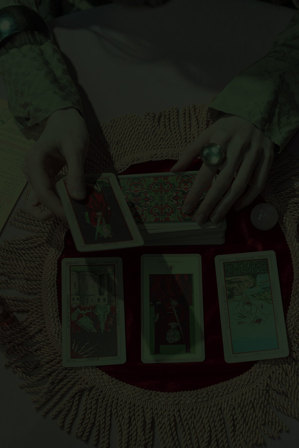 Hands performing a tarot reading, reflecting the arcane and magical spirit of the Mystic collection by Fabled Fox Clothiers.